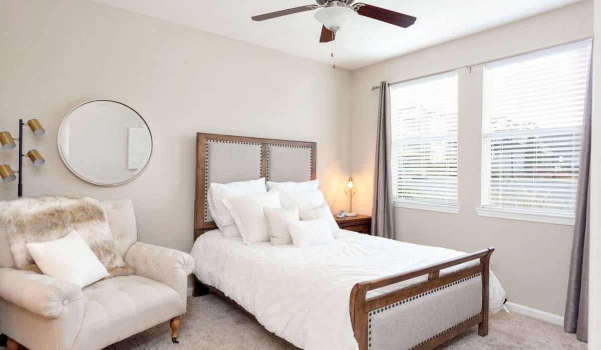 Bedroom with sofa side by  at Arch Street in Madison, Alabama