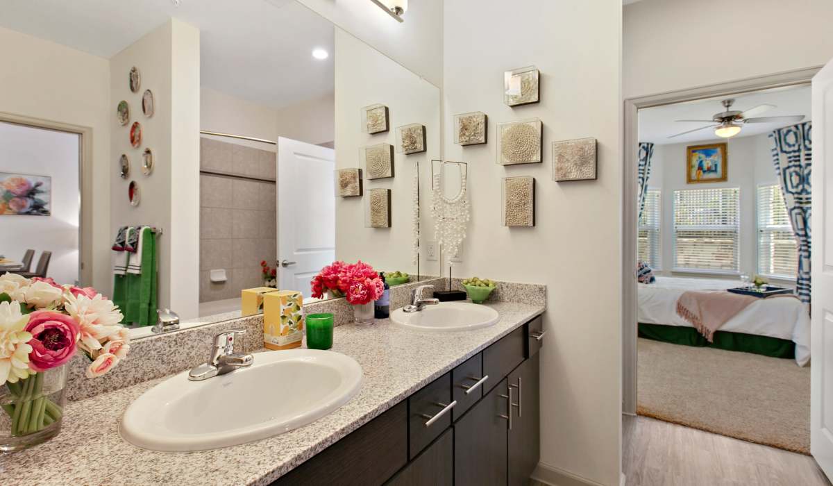 Bright bathroom with vanity lights and connected to bedroom at Sadler House in San Marcos, Texas, 
