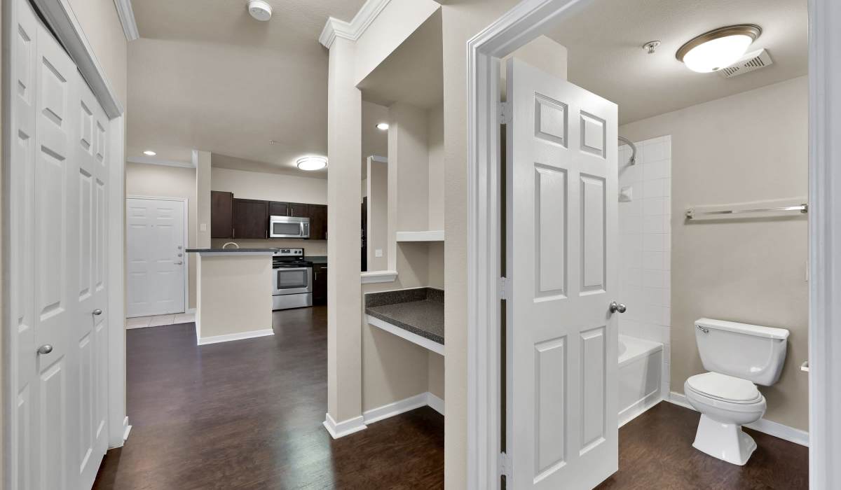 Spacious hallway with a view of the bathroom at Whispering Pines Ranch in The Woodlands, Texas