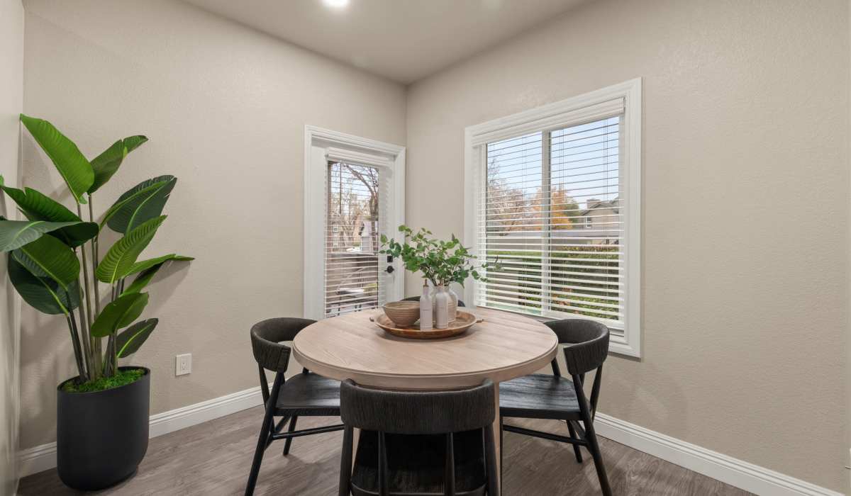 A cozy dining room featuring a wooden table surrounded by elegant chairs, perfect for family gatherings at The Preserve at Creekside in Roseville, California  