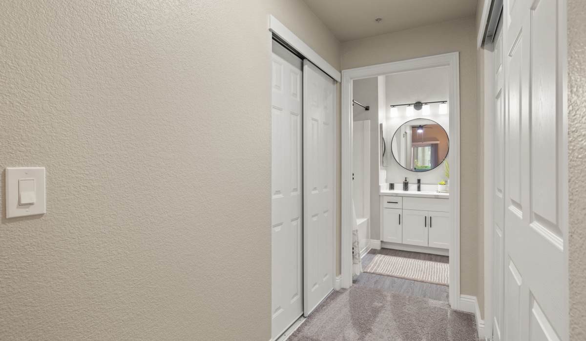 A clean bathroom featuring a white sink, toilet, and mirror, showcasing a modern and minimalist design at The Preserve at Creekside in Roseville, California  