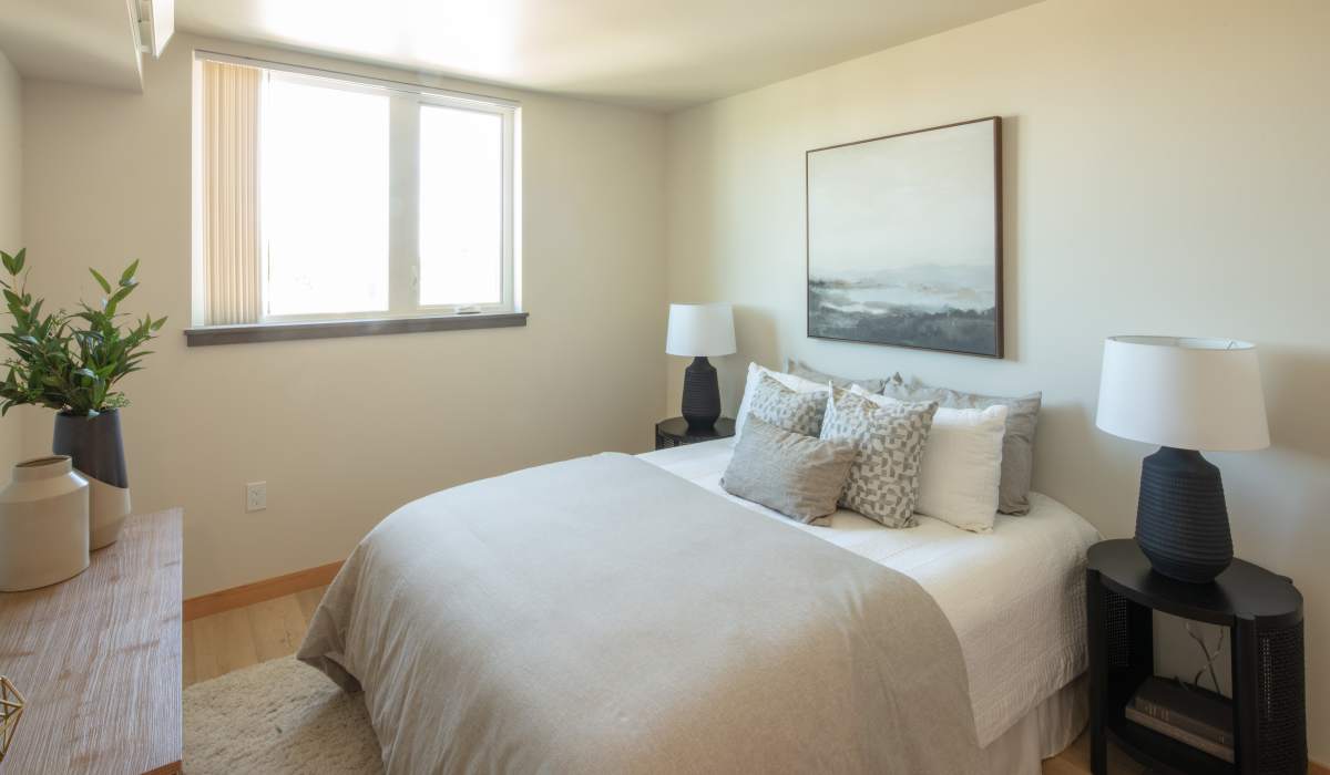 White-themed bedroom at Bryant Manor North in Seattle, Washington