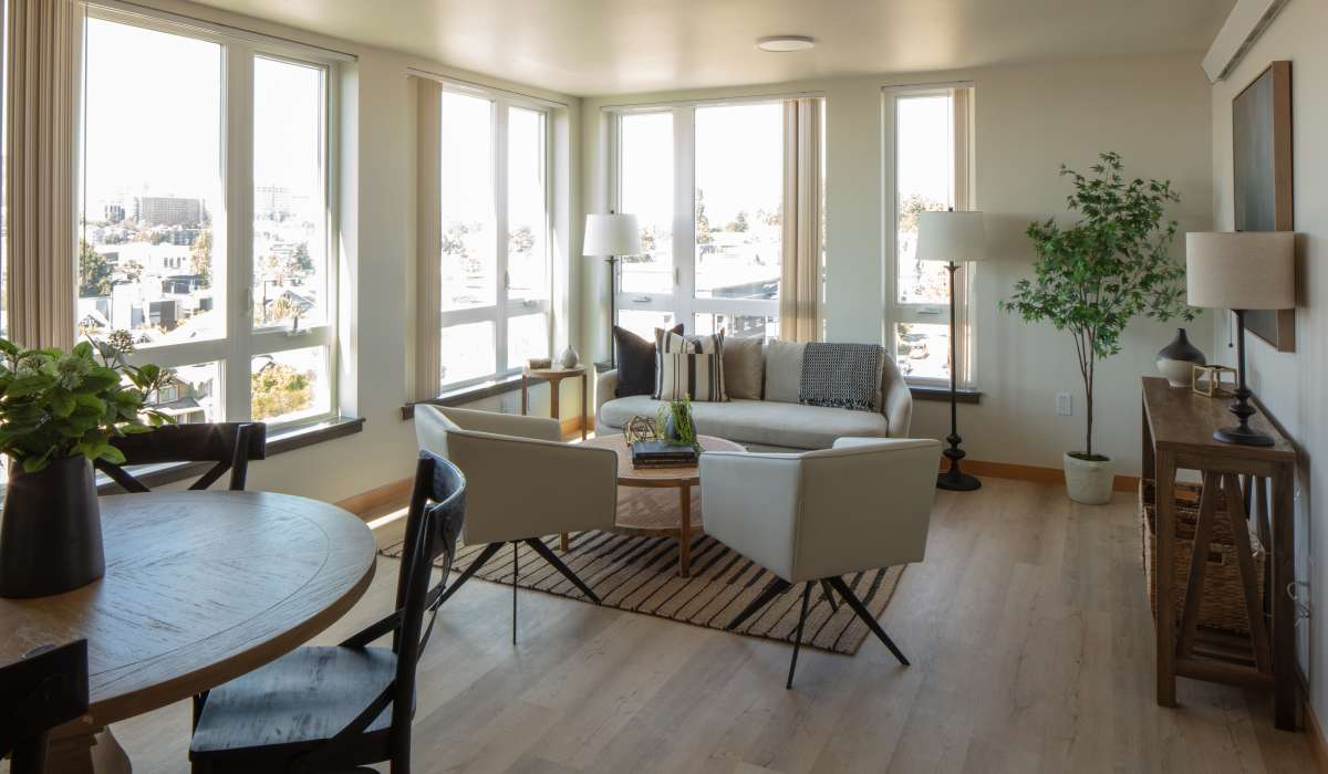 Spacious living room with floor to ceiling glass wall at Bryant Manor North in Seattle, Washington