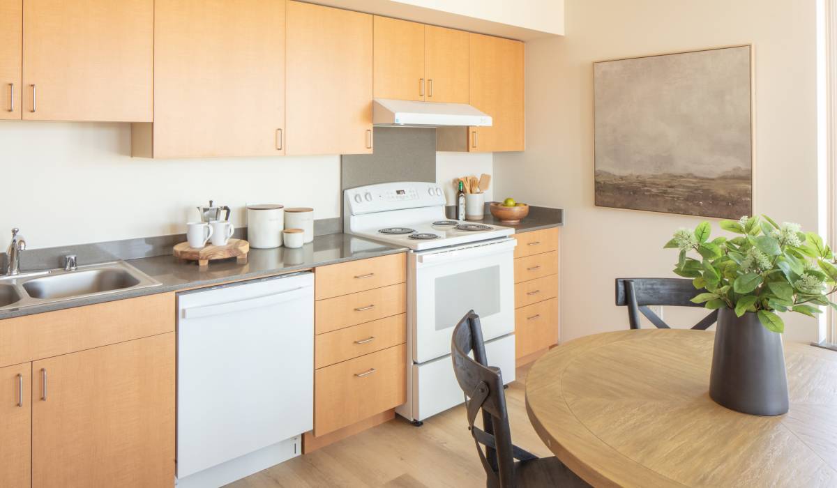 Beautiful kitchen with appliances and wooden cabinet at Bryant Manor North in Seattle, Washington