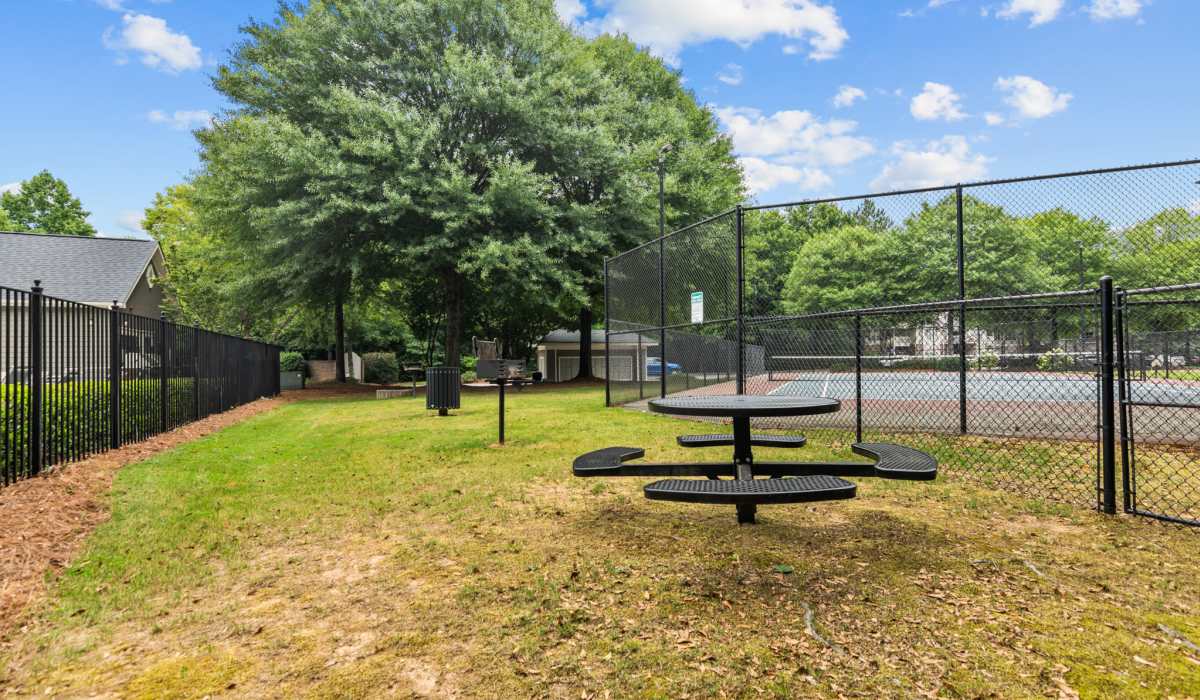Community outdoor area near tennis court at The Grove on Southlake in Morrow, Georgia