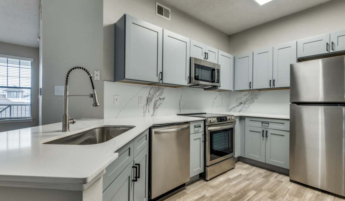 Kitchen with quartz countertops at Devi at Valley Ranch in Irving, Texas