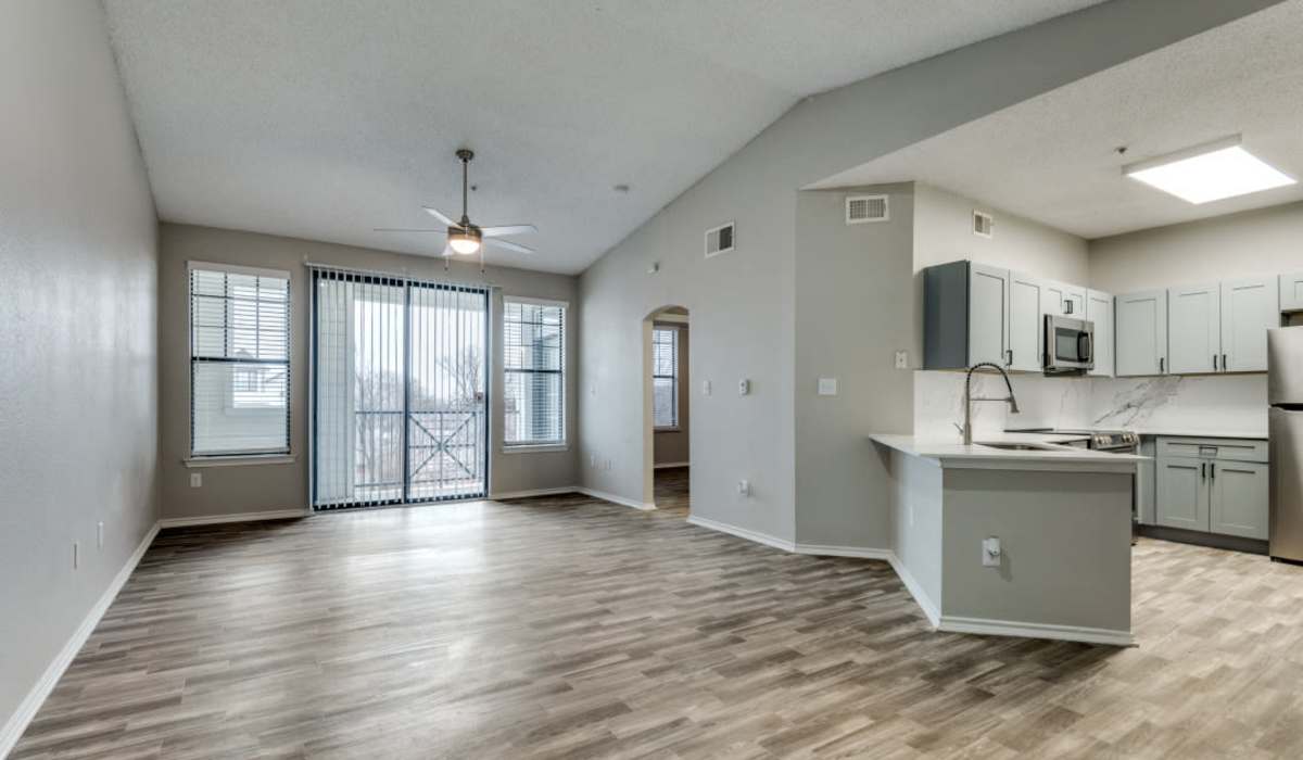 Living room with wood-style flooring at Devi at Valley Ranch in Irving, Texas