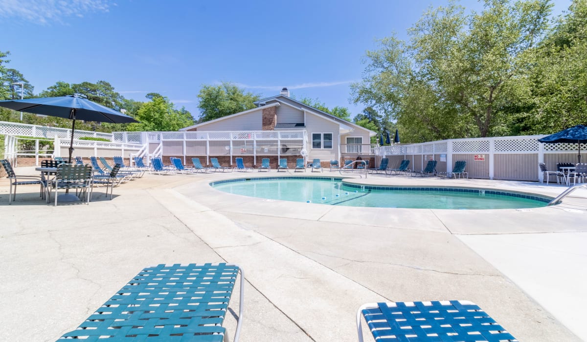 Pool with chairs at Tamarack on the Lake in Fayetteville, North Carolina