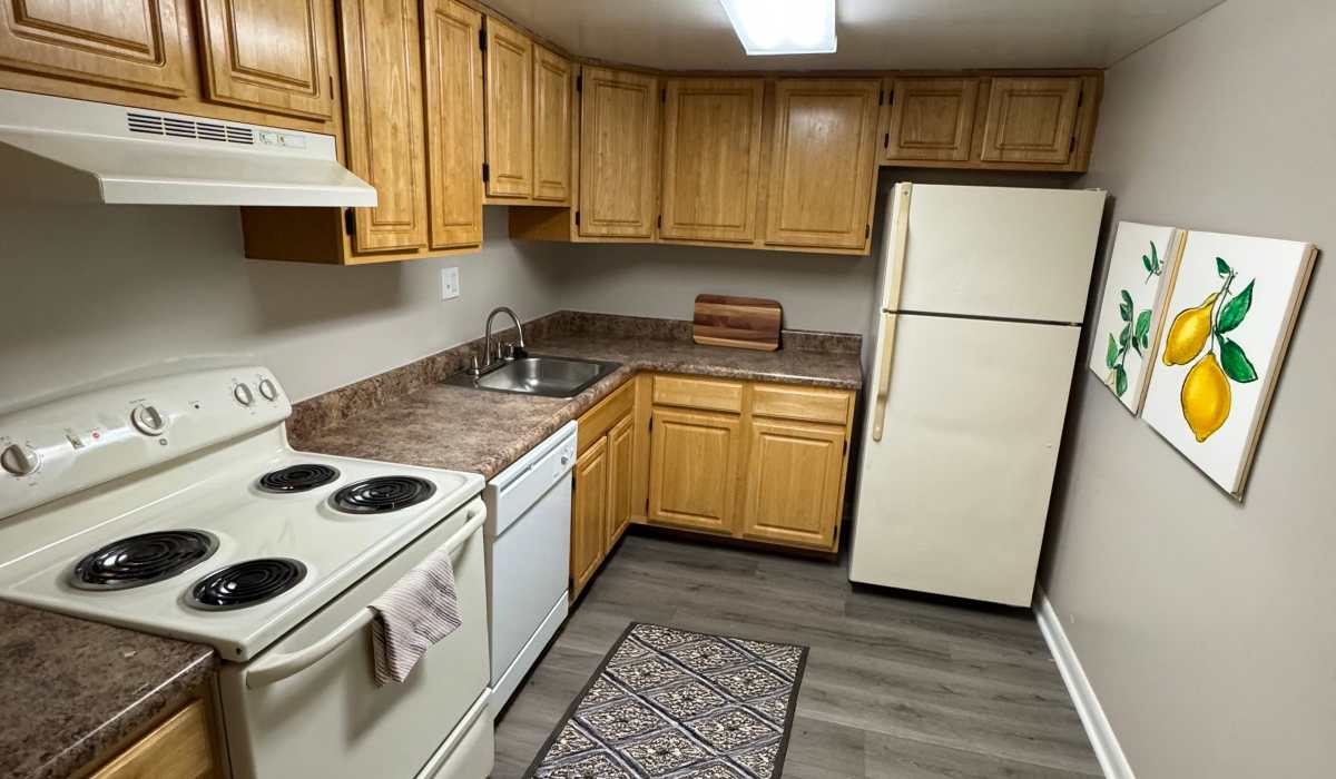 Apartment kitchen with stainless steel finishes at Towne Crest in Gaithersburg, Maryland