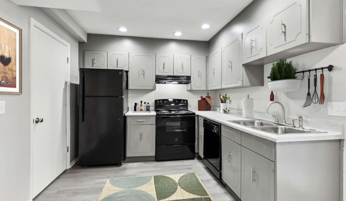 Kitchen with wood cabinetries at Country Oaks Apartments in Hixson, Tennessee