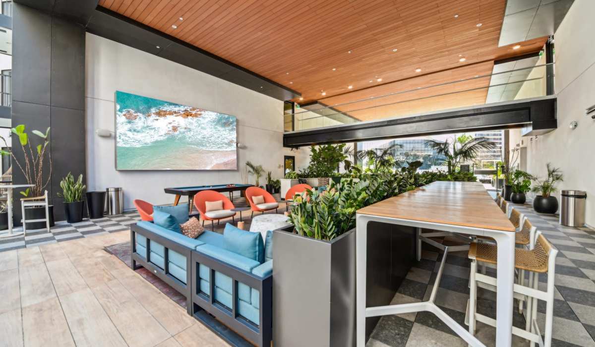 Recreation area with pool table, chairs and long table at Aster in Long Beach, California