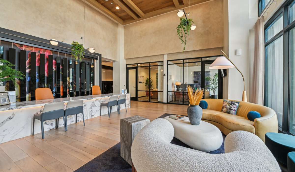 Reception area with comfortable sofas and chairs at Aster in Long Beach, California