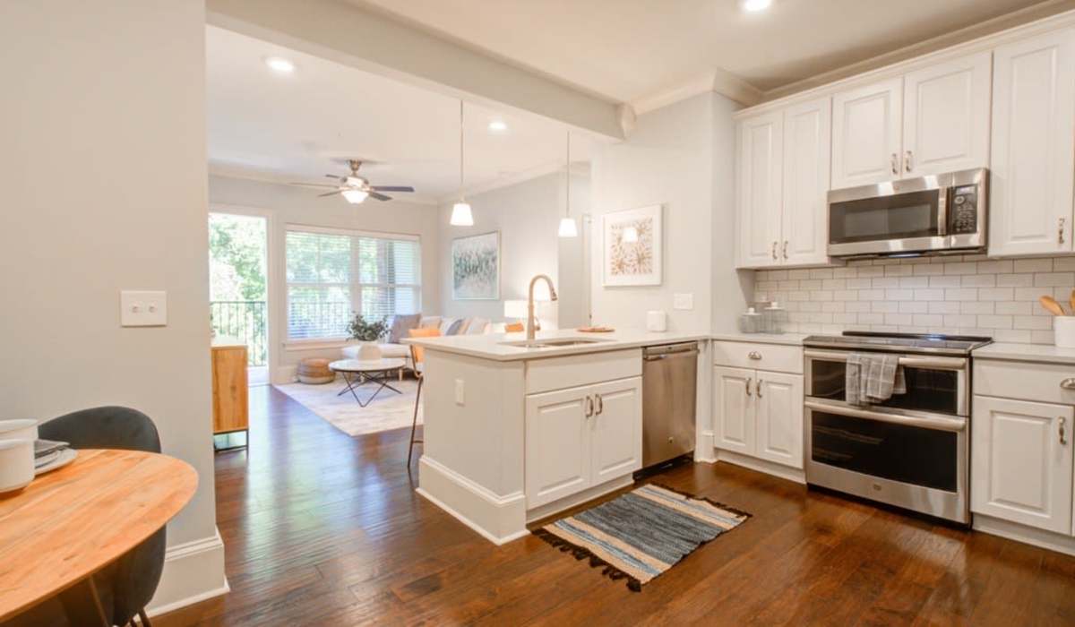 Apartment kitchen with stainless-steel appliances and quartz countertops at 511 Queens in Charlotte, North Carolina
