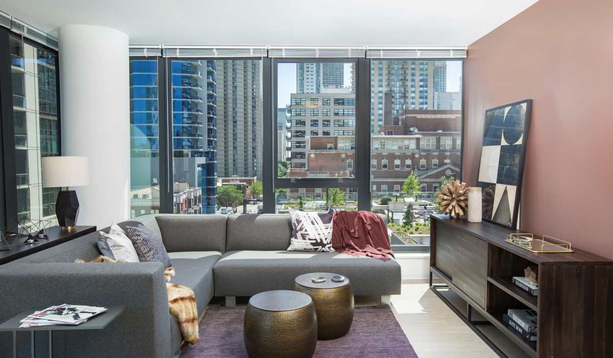 Beautiful living room with large windows at Exhibit On Superior in Chicago, Illinois