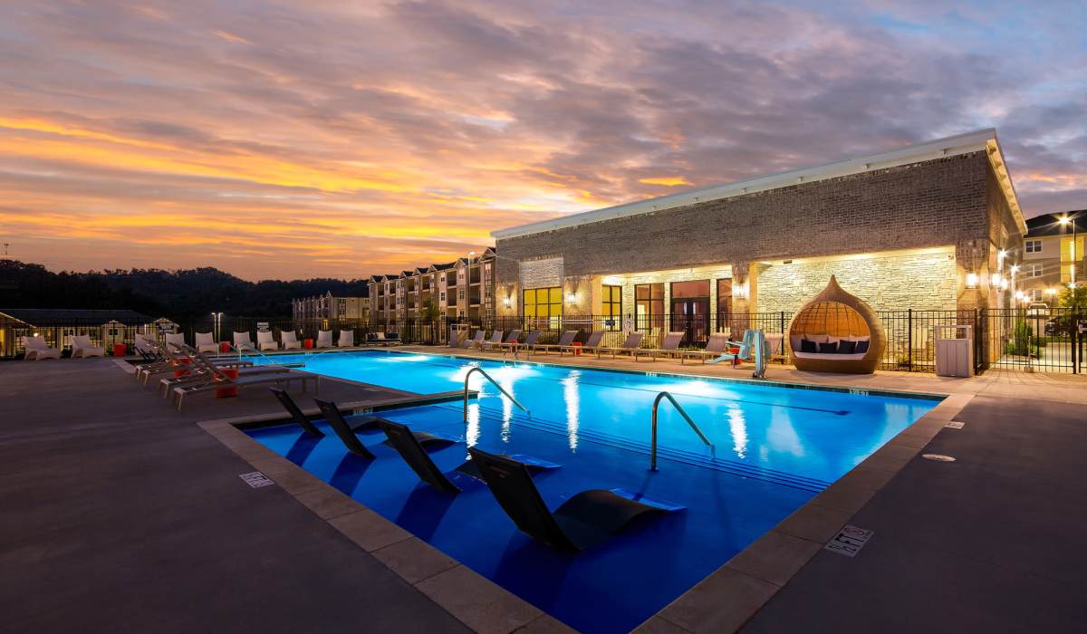 Sparkling pool with laid back chairs at Elevate at Topside in Louisville, Tennessee