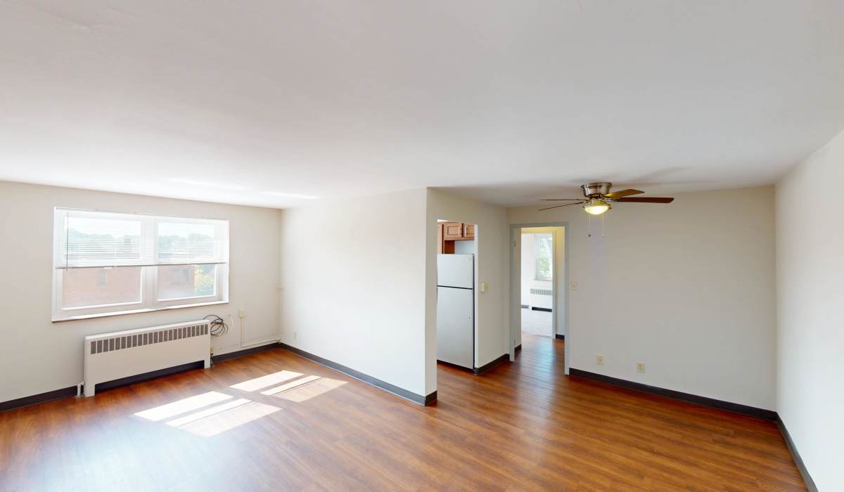 Living room with wood-style flooring at Lebanon Vue in Pittsburgh, Pennsylvania