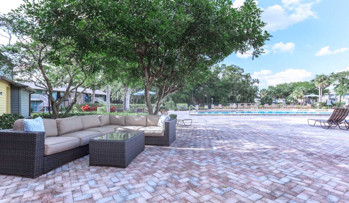 Lounge area by the pool at Fountains at Forestwood in Fort Myers, Florida