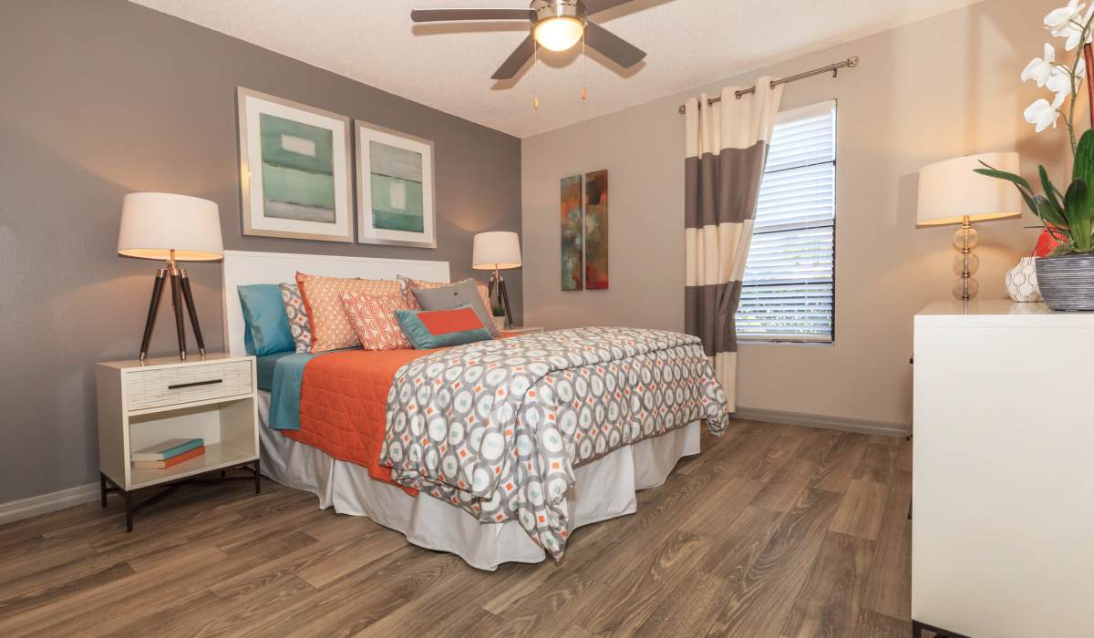 Wood-style flooring in a bedroom at Fountains at Forestwood in Fort Myers, Florida