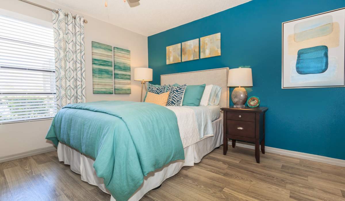 Bedroom with a blue accent wall at Fountains at Forestwood in Fort Myers, Florida
