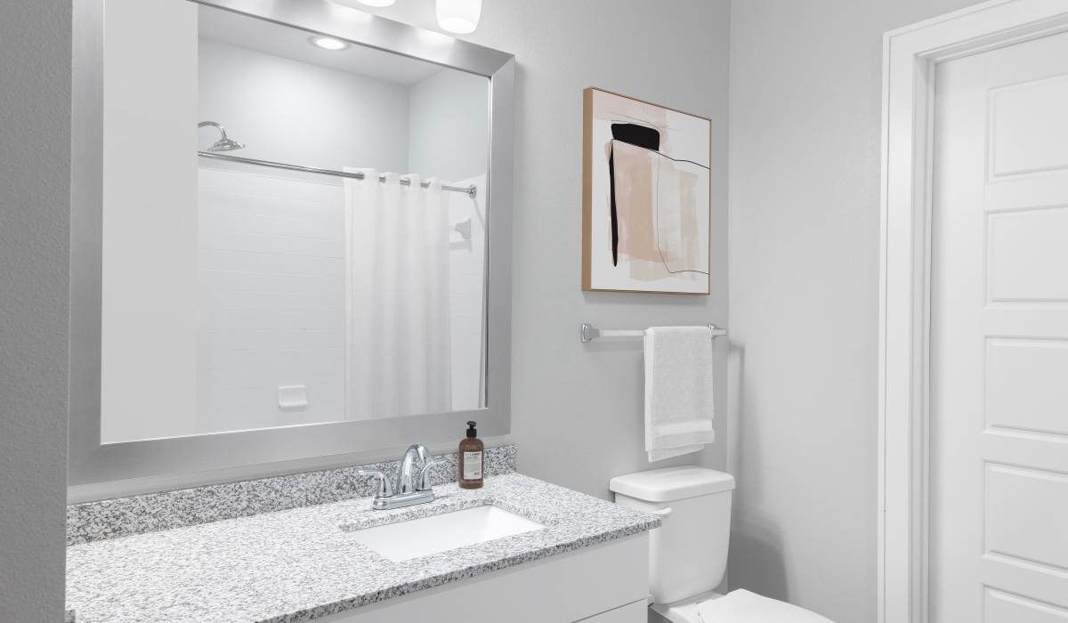 Bright bathroom with pendant lights at Vale Overland Park Apartments in Overland Park, Kansas, 