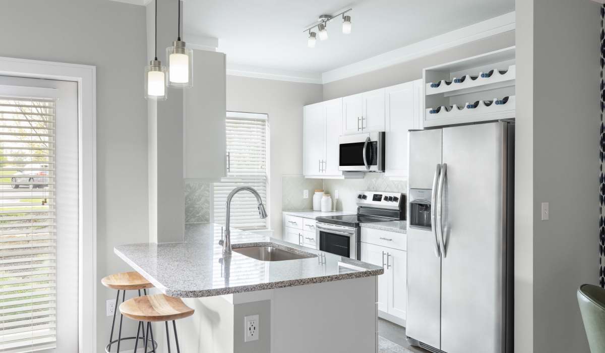 Spacious island kitchen with pendant lights at Vale Overland Park Apartments in Overland Park, Kansas,   
