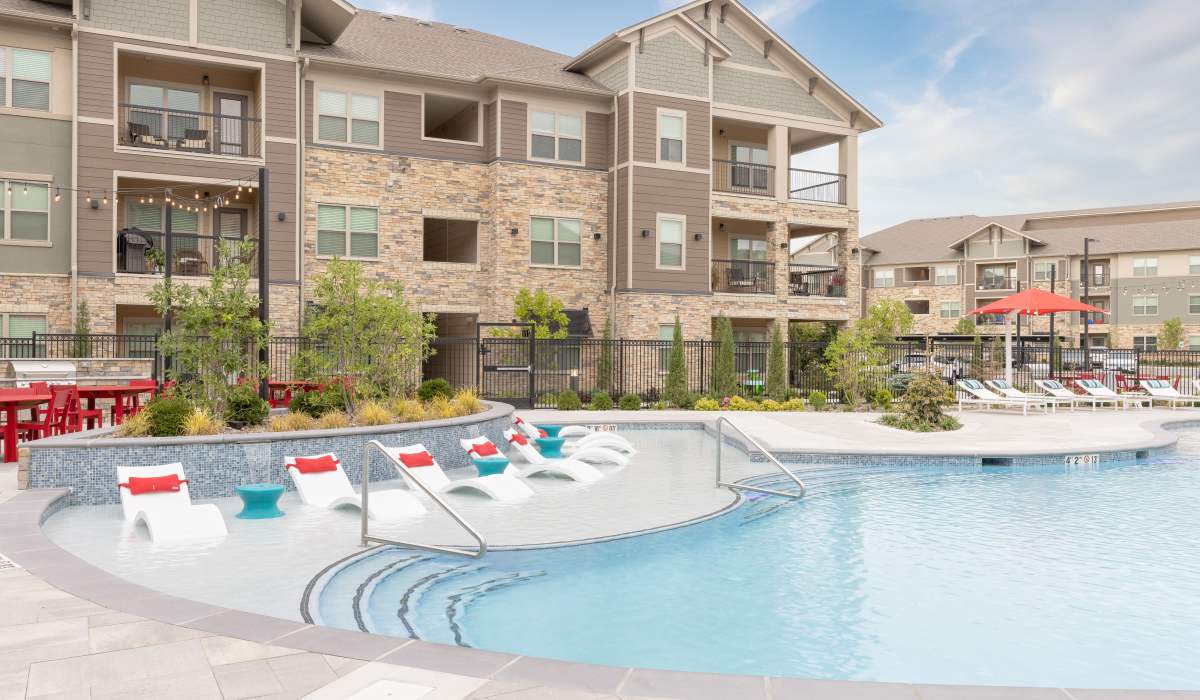 Large swimming pool with lounge beds at Vale Overland Park Apartments in Overland Park, Kansas, 