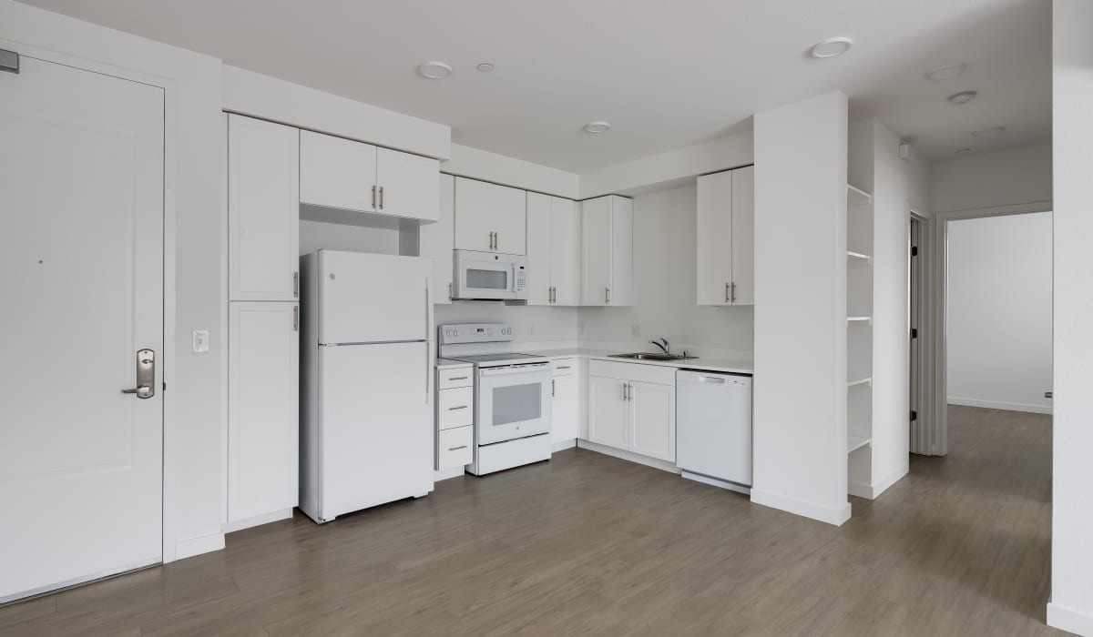Kitchen with wood-style flooring at Village at First in Gilroy, California