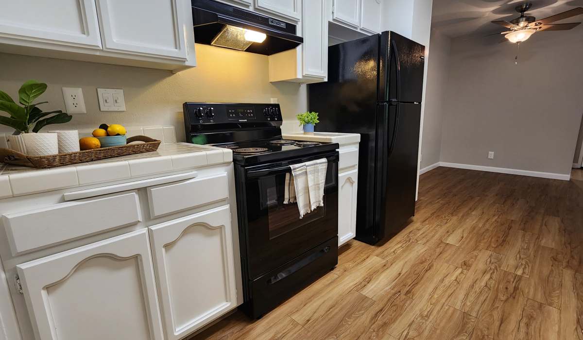 Updated kitchen with white cabinetry at Cobble Creek Apartment Homes in Chico, California