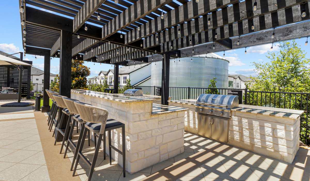 Grilling area by the pool at Luxe Of Buda in Buda, Texas