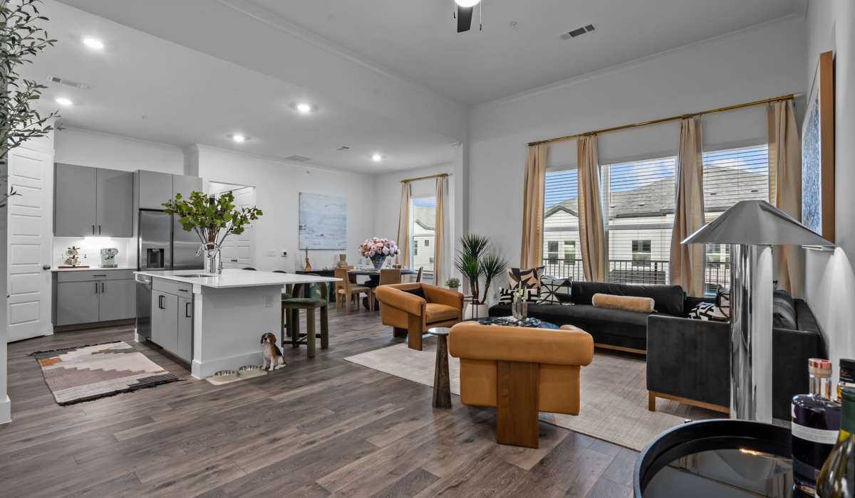 Living room with wide plank flooring at Luxe Of Buda in Buda, Texas