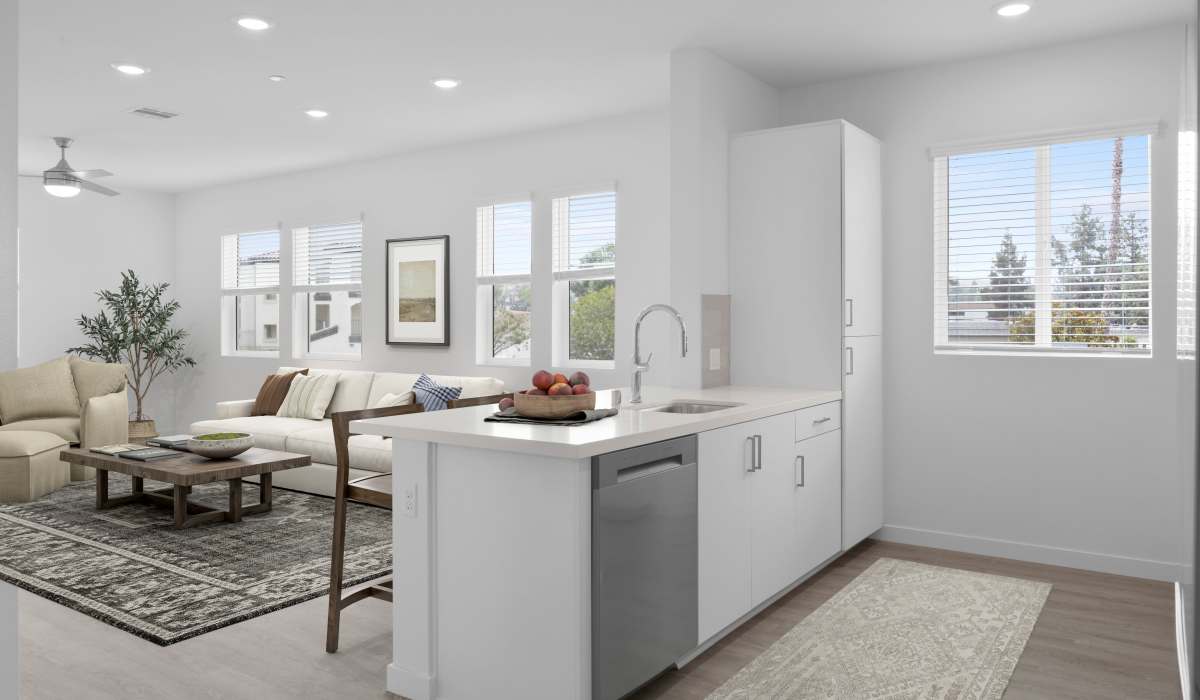 Cozy and modern living room and kitchen interior with plenty of sunlight at Canyon Bluffs Apartment Homes in Riverside, California