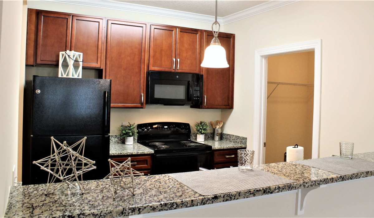 Spacious island kitchen with pendant lighting and granite countertops at Palisades of Fountain Inn in Fountain Inn, South Carolina, 