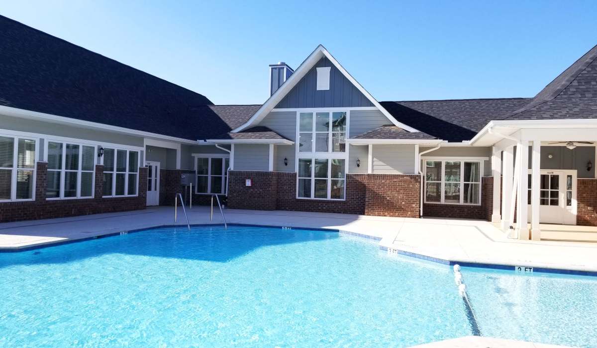Community exterior with resort-style swimming pool at Palisades of Fountain Inn in Fountain Inn, South Carolina, 