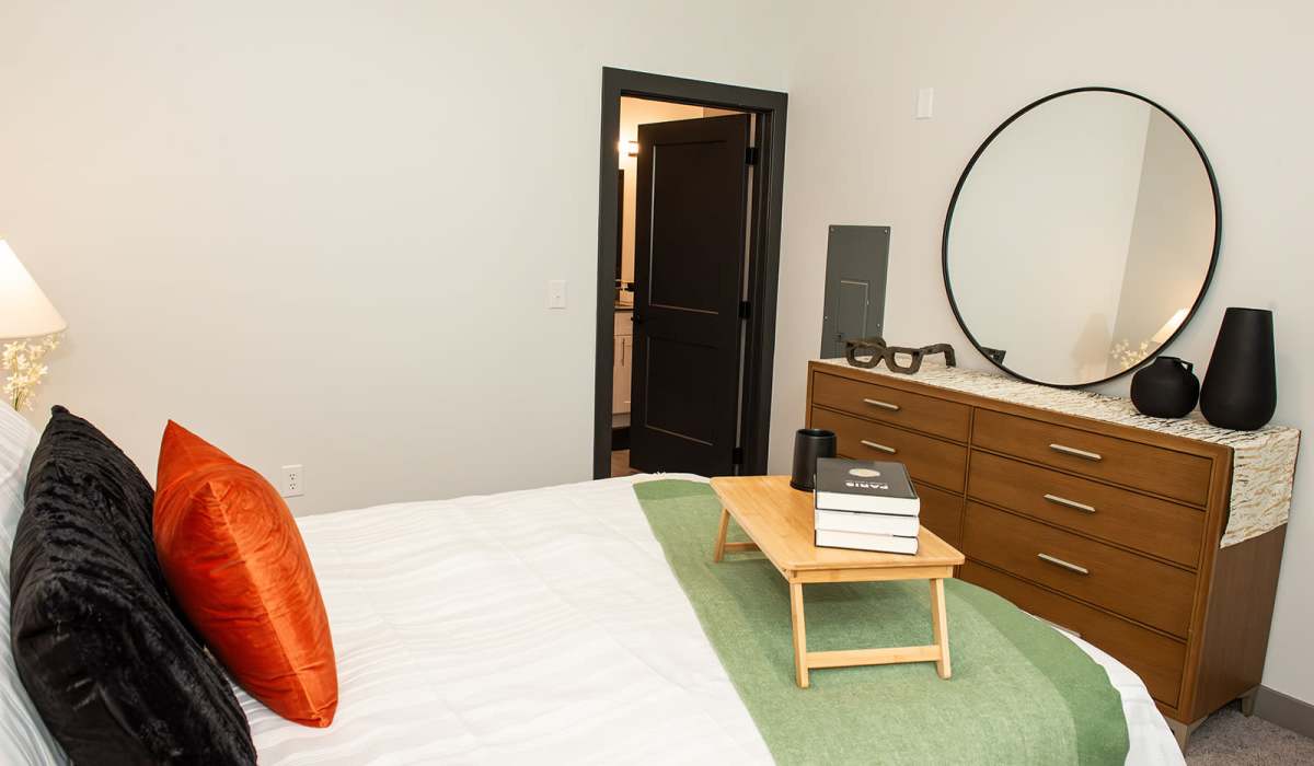 Bedroom with dresser at The Apartments at 1st on Main in Carmel, Indiana