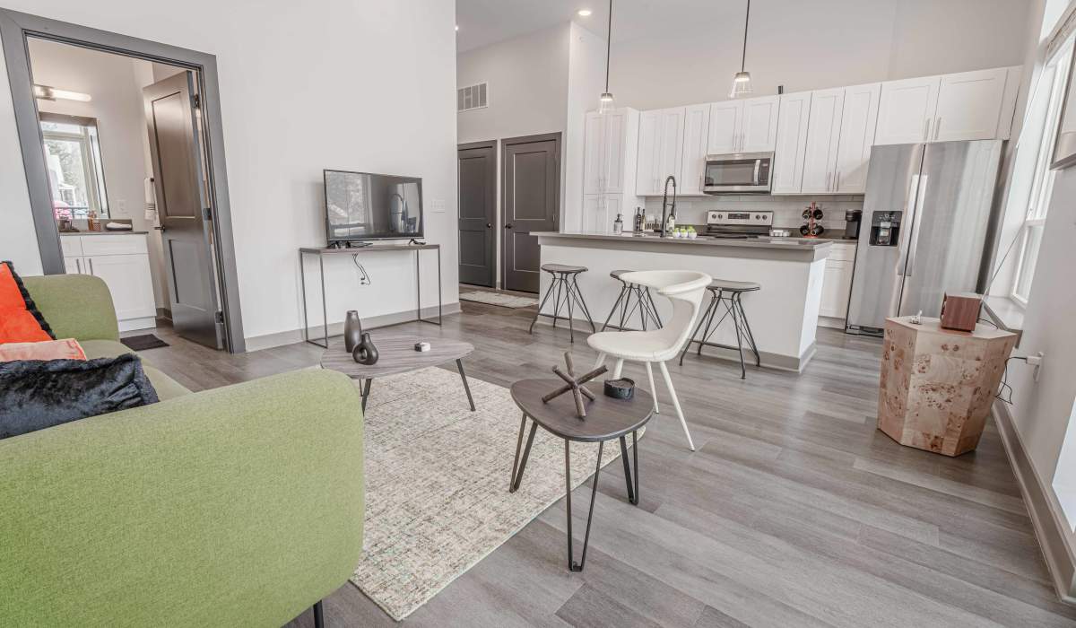 Living room with television at The Apartments at 1st on Main in Carmel, Indiana