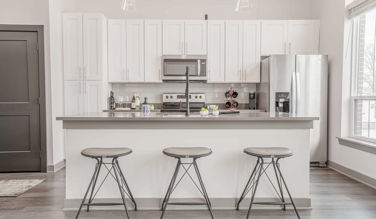 kitchen with barstools at The Apartments at 1st on Main in Carmel, Indiana
