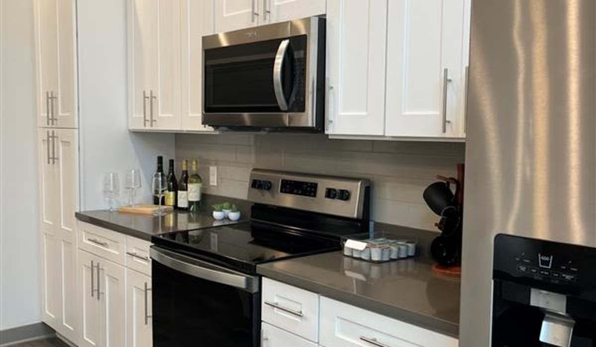 Kitchen with electric range at The Apartments at 1st on Main in Carmel, Indiana