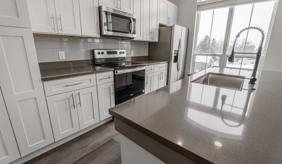 Kitchen with white color cabinets at The Apartments at 1st on Main in Carmel, Indiana
