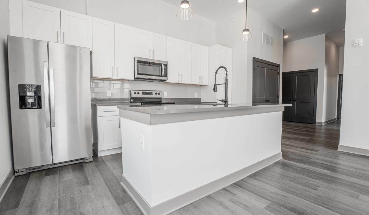 Kitchen with side by side refrigerator at The Apartments at 1st on Main in Carmel, Indiana 