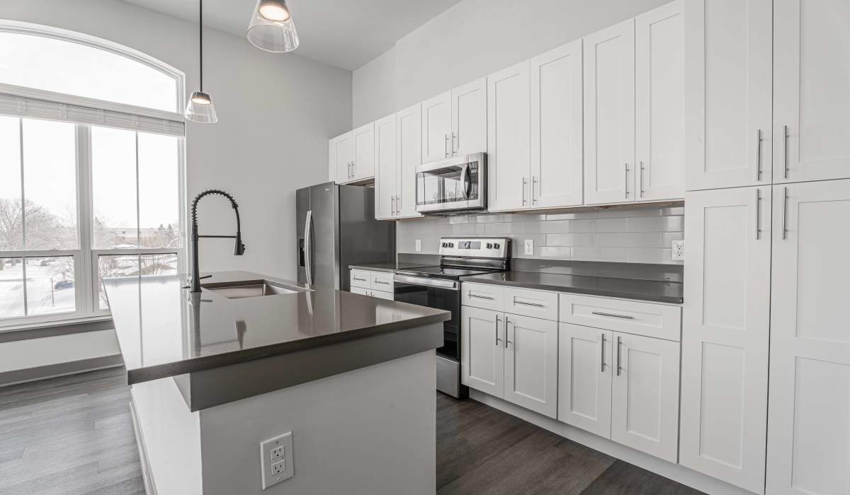 Kitchen with full height window at The Apartments at 1st on Main in Carmel, Indiana
