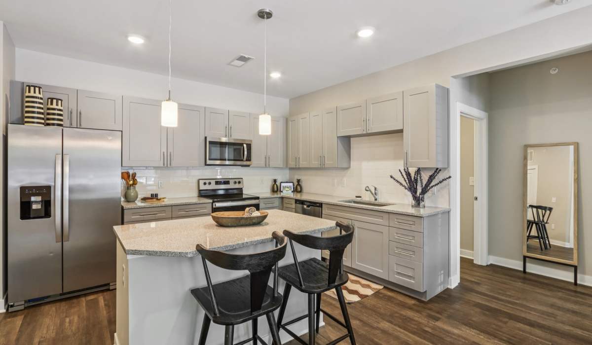 Kitchen with wooden cabinets and breakfast counter at Founders Pointe Apartments in Franklin, Indiana