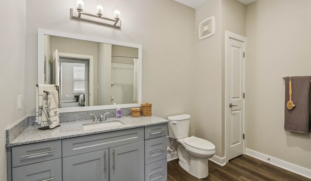Bathroom with a toilet, and a mirror at Founders Pointe Apartments in Franklin, Indiana