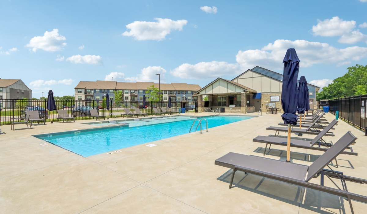 Swimming pool with multiple lounge chairs at Founders Pointe Apartments in Franklin, Indiana