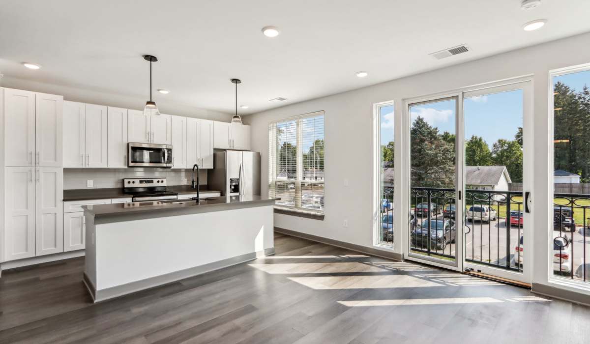 Unfurnished living area with attached patio at The Apartments at 1st on Main in Carmel, Indiana 