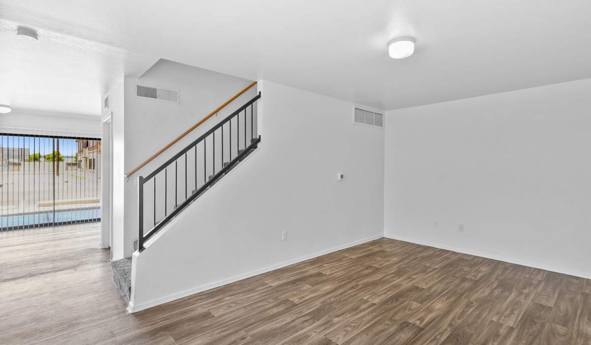 Duplex apartment living room with stairwell access at Bella Vista Apartments in Phoenix,Arizona