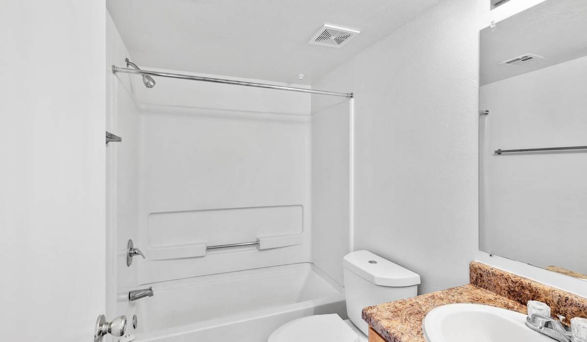 Bright bathroom with white vanity unit at Bella Vista Apartments in Phoenix,Arizona