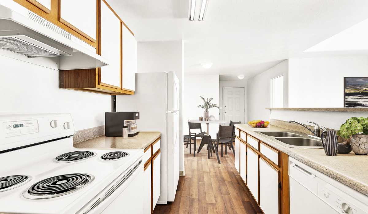 Modern kitchen with wooden cabinets at Tierra Antigua Apartments in Mesa, Arizona