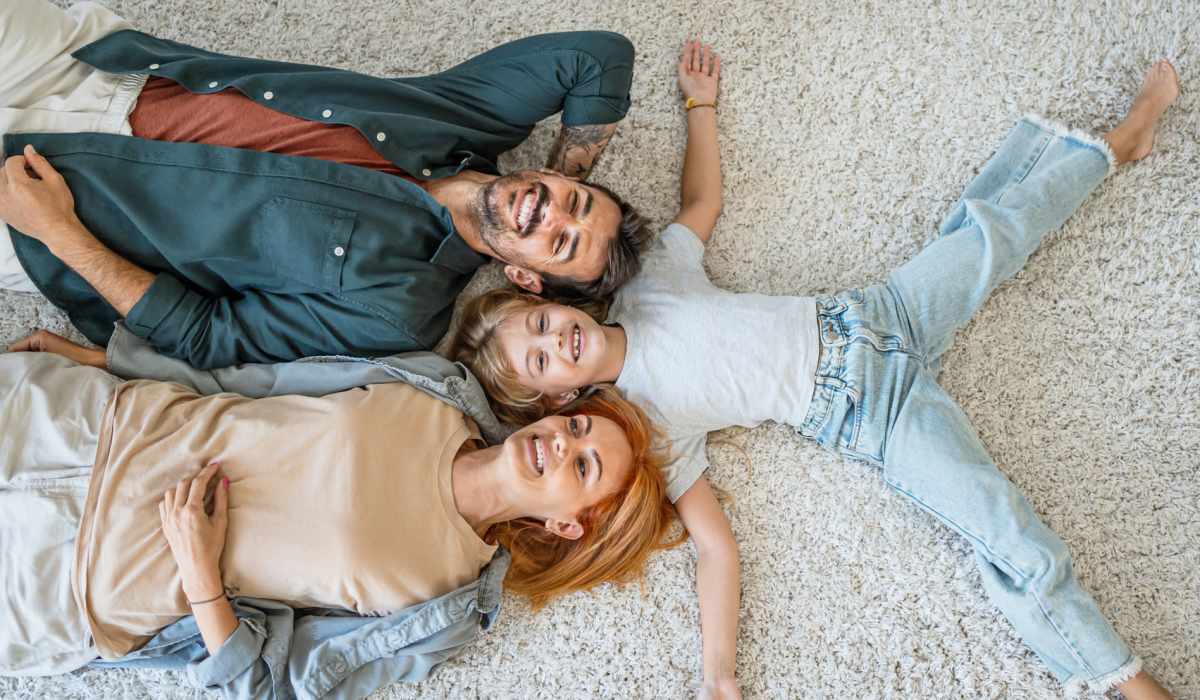 A happy resident family lying on the floor at Parkland Village in District Heights,Maryland