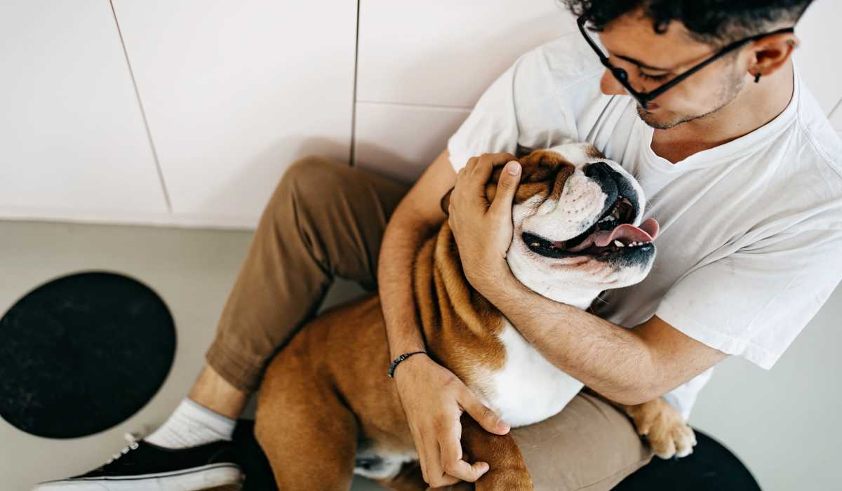 Resident petting his dog at Venable Durham Apartments in Durham, North Carolina