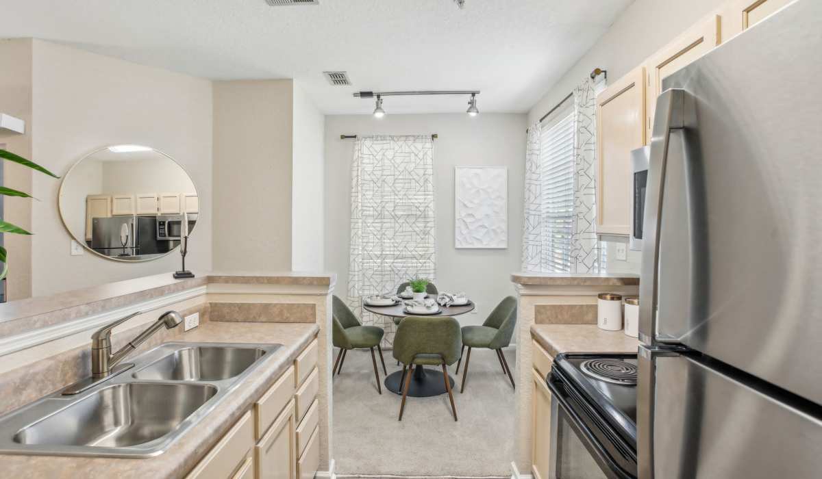 Spacious kitchen with ample counter space and cabinetry and wood style flooring at Sole at Citrus Park apartments in Tampa, Florida.